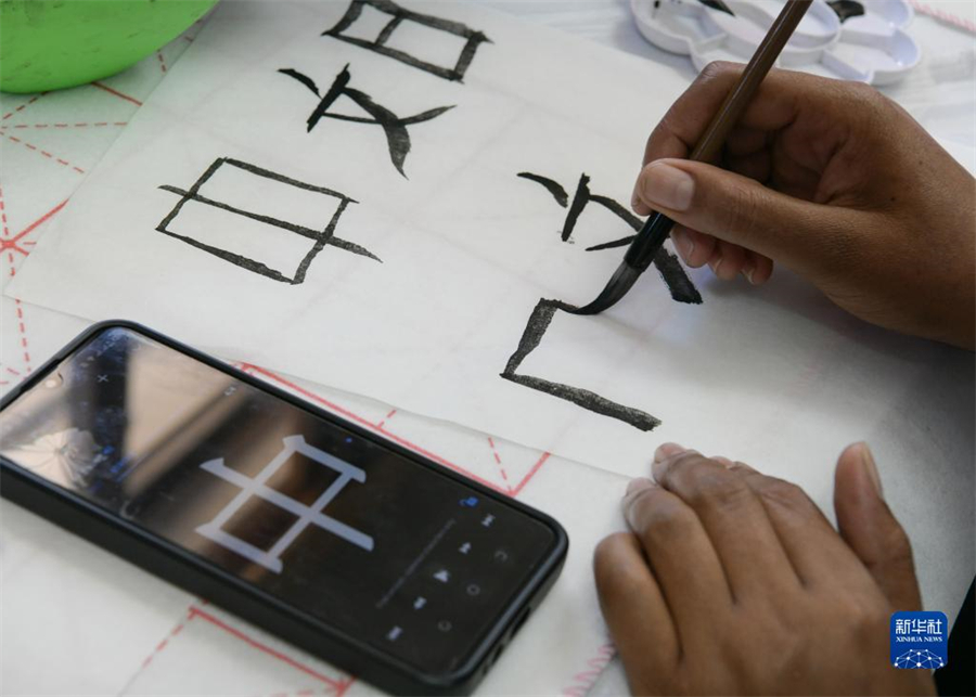 4月18日，肯尼亞學(xué)生在內(nèi)羅畢大學(xué)孔子學(xué)院舉辦的活動上寫毛筆字?？夏醽唭?nèi)羅畢大學(xué)孔子學(xué)院18日舉辦“中文，增進(jìn)文明對話”主題活動，慶祝即將到來的第14個聯(lián)合國中文日?？夏醽唽W(xué)生參與互動，進(jìn)行書法、剪紙、唱中文歌等活動。新華社記者 韓旭 攝