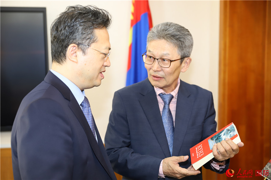 其米德策耶（右一）向李峙介紹翻譯成果。人民網(wǎng)記者 霍文攝