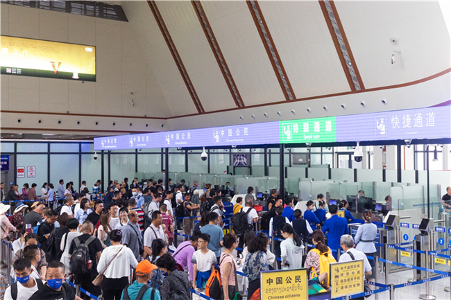 7月22日，乘坐中老鐵路國際旅客列車的旅客在磨憨邊檢大廳排隊候檢。衛(wèi)海林 攝