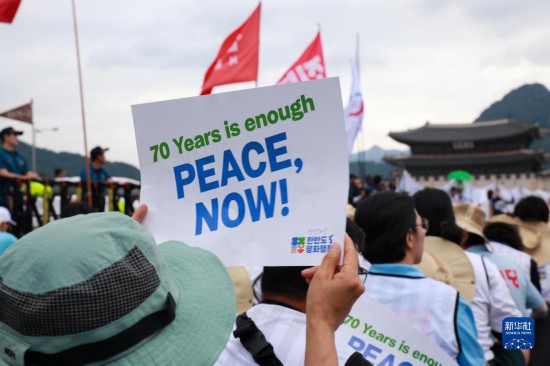 7月22日，在韓國首爾，人們手舉標(biāo)語參與反戰(zhàn)游行。新華社發(fā)（楊暢 攝）