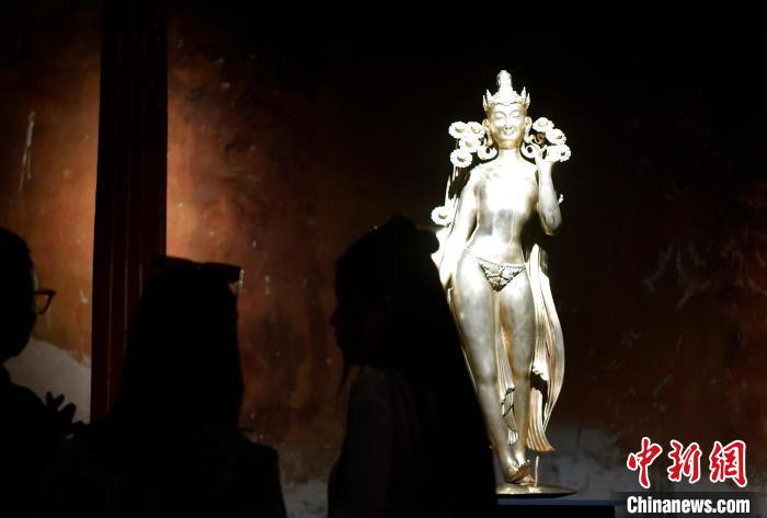 圖為觀眾正在欣賞展覽中的雕塑作品《八萬四千年》?！±盍?攝